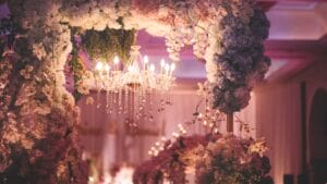 A wedding reception decorated with flowers and a chandelier.